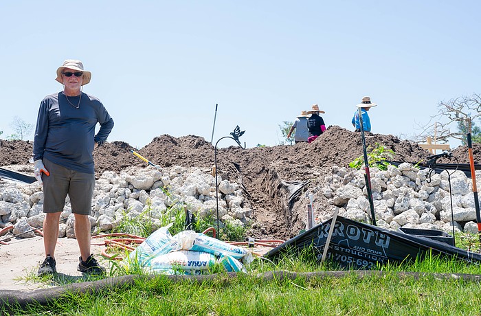 Eddie Abrams stands at the base of his raised lot on Longboat Drive North where he is building his insulating concrete form house. Abrams and his son are both rebuilding on raised lots after Hurricane Helene caused severe flooding on Longboat Key.