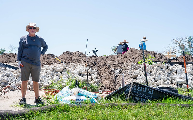 Eddie Abrams stands at the base of his raised lot on Longboat Drive North where he is building his insulating concrete form house. Abrams and his son are both rebuilding on raised lots after Hurricane Helene caused severe flooding on Longboat Key.
