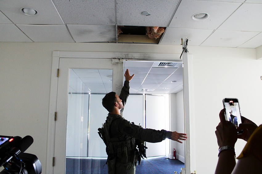 The charge didn't break the glass of a set of French doors the Sarasota Police Department practiced opening with explosives, but the energy did transfer to the ceiling, as Sgt. Aaron Stoll shows.