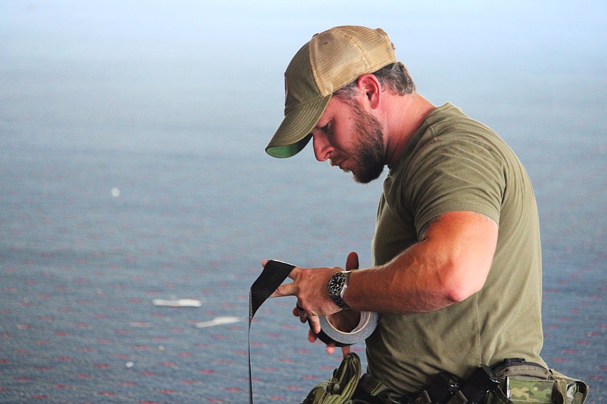 Sarasota Police Department Officer Kyle Carter makes preparations for an explosives training hosted by Bird Key Yacht Club at its soon-to-be-demolished clubhouse on Sept. 5.