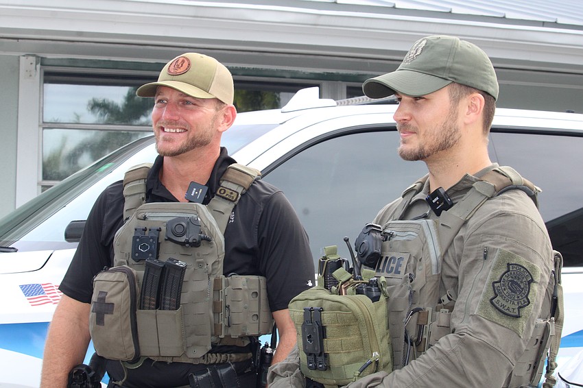 Sgts. Dustin Luciano and Aaron Stoll explain the purpose of a Sarasota Police Department explosive entry training at Bird Key Yacht Club on Sept. 5.