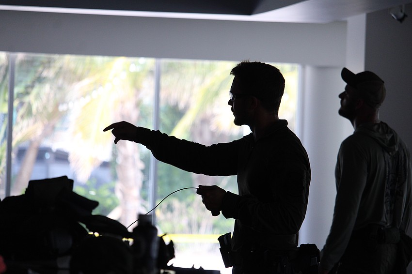 The demolition team at the Sarasota Police Department, including Sgt. Aaron Stoll, make final preparations for the explosion training at Bird Key Yacht Club on Sept. 5.