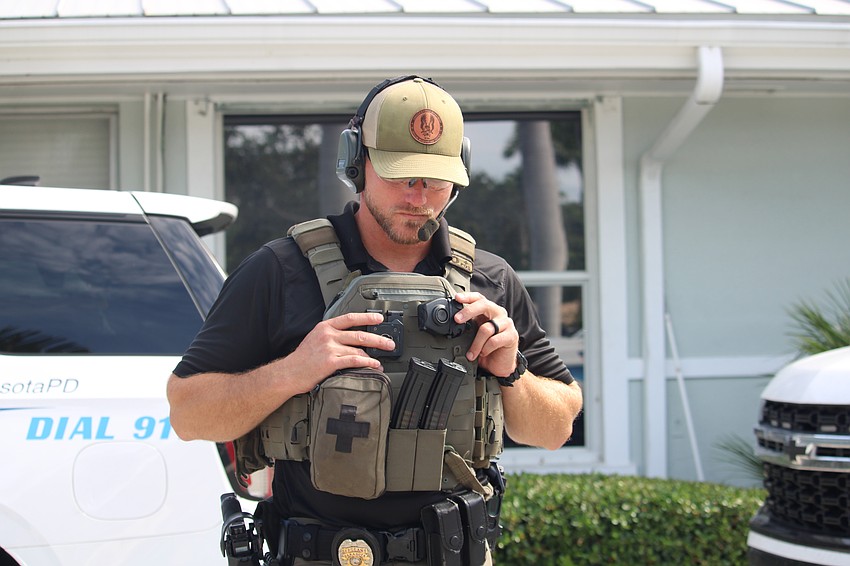 Sarasota Police Department Sgt. Dustin Luciano, the team leader at a Sept. 5 explosives exercise at Bird Key Yacht Club, listens in ahead of the final countdown.