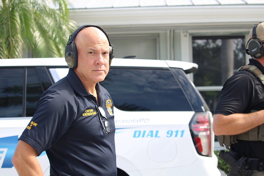 Sarasota Police Department Captain Demetri Konstantopoulos dons ear protection for the final countdown at an explosives training session.