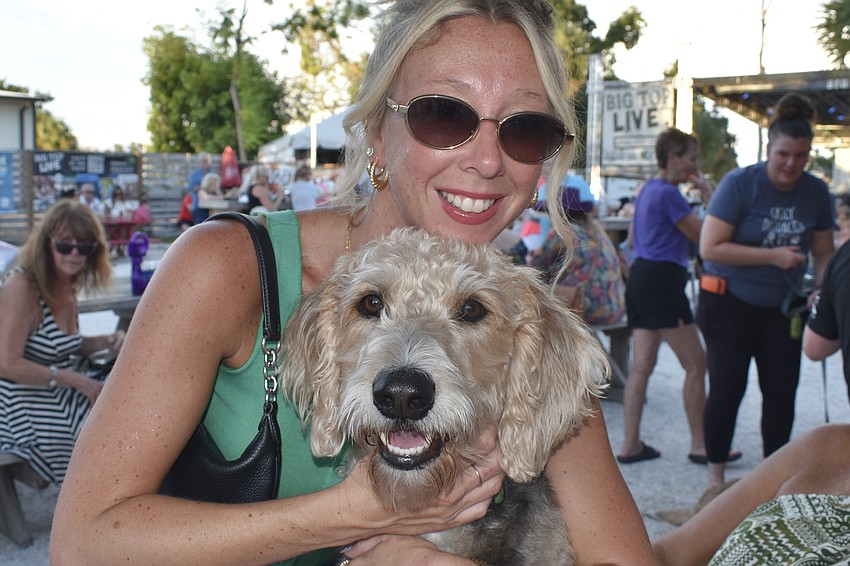 Krystal Vogel holds her mother-in-law Sharon Vogel's dog Kobe, a hybrid of a Poodle and a Louisiana hunting breed.