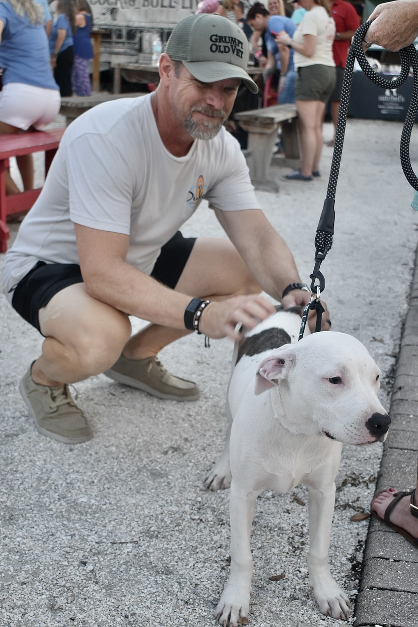 Cliff Scarborough pets Brittany Conrad's Pit Bull Mix, Dobby.