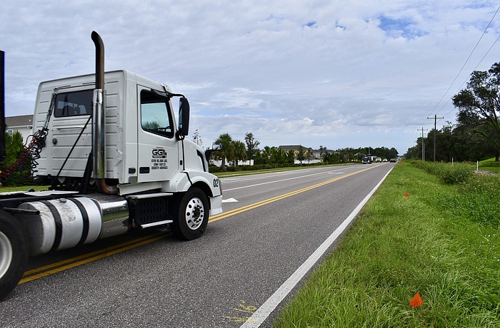 A semi takes a wide turn onto Lorraine Road from 44th Avenue East.
