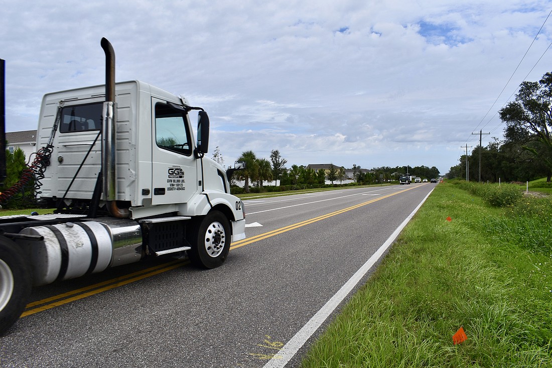 A semi takes a wide turn onto Lorraine Road from 44th Avenue East.