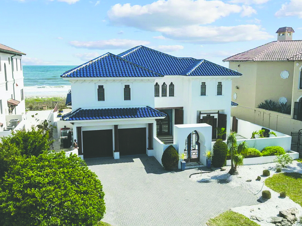 Oceanfront two-story home features four bedrooms, five bathrooms, pool porches, patio, outdoor kitchen and dune walkover.