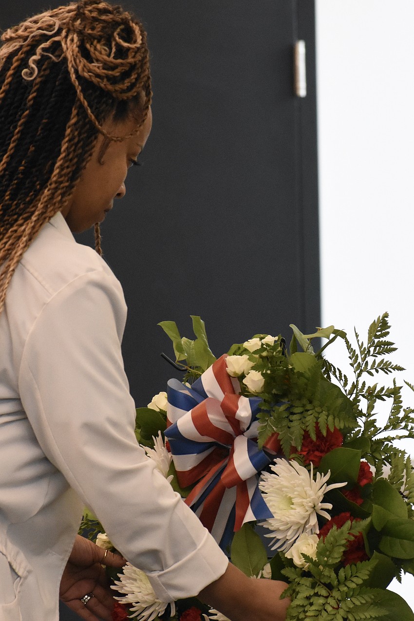 Shavon Clark Harris, representing emergency medical technicians and medical personnel, lays a wreath.