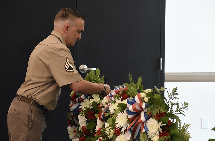 Staff Sergeant Matthew B. Miles of the United States Army, representing all military personnel, lays a wreath.