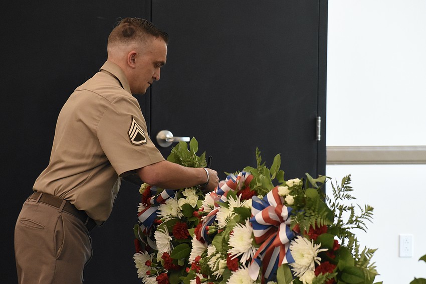 Staff Sergeant Matthew B. Miles of the United States Army, representing all military personnel, lays a wreath.