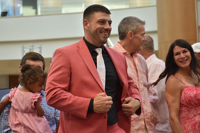 Blake Fitzpatrick, the owner of Sunshine Movers, is a Men Wear Pink co-chair alongside Joy Mclean. He sports a rose suit from Men's Warehouse.