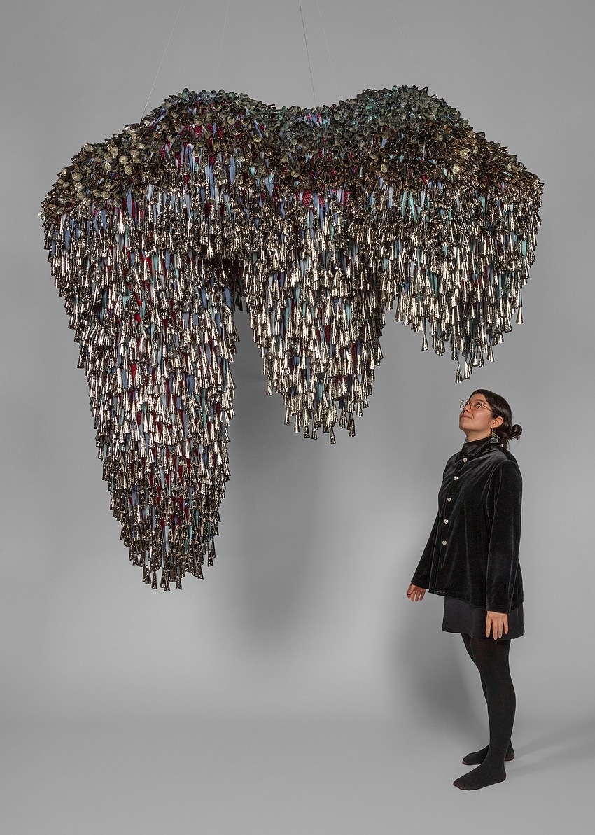 Artist Marie Watt stands underneath