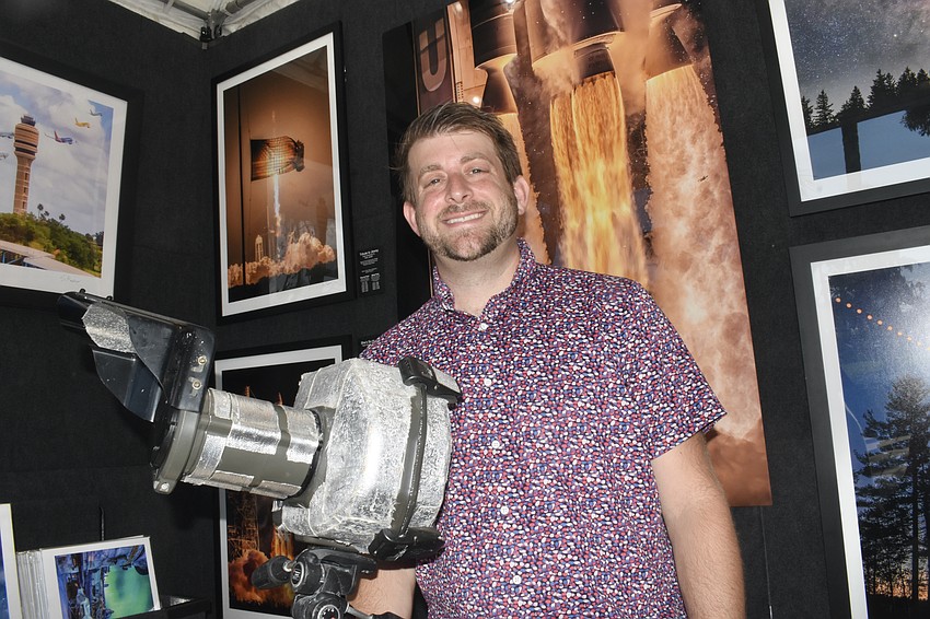 Orlando photographer Steven Madow showcased his photographs of rocket launches, taken with special clearance from NASA. He is posing with a housing he uses to protect his sound-activated cameras, which he places a few hundred feet from the launches, where they will be engulfed in flames.