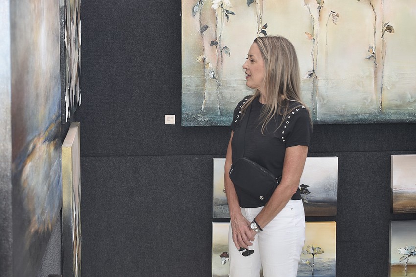Carey Hofle admires the artwork of Orlando artist Susan Sobel.
