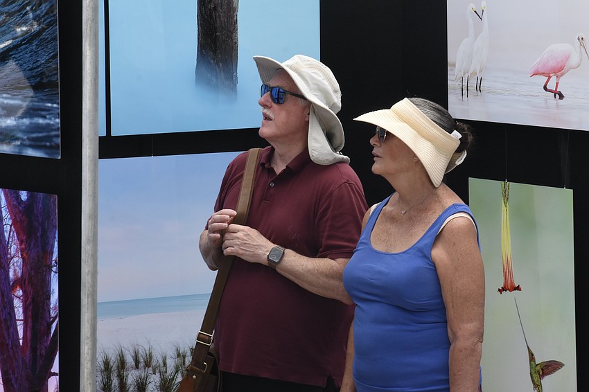 James Mann and Linda Rock of Port St. Lucie admire the artwork.