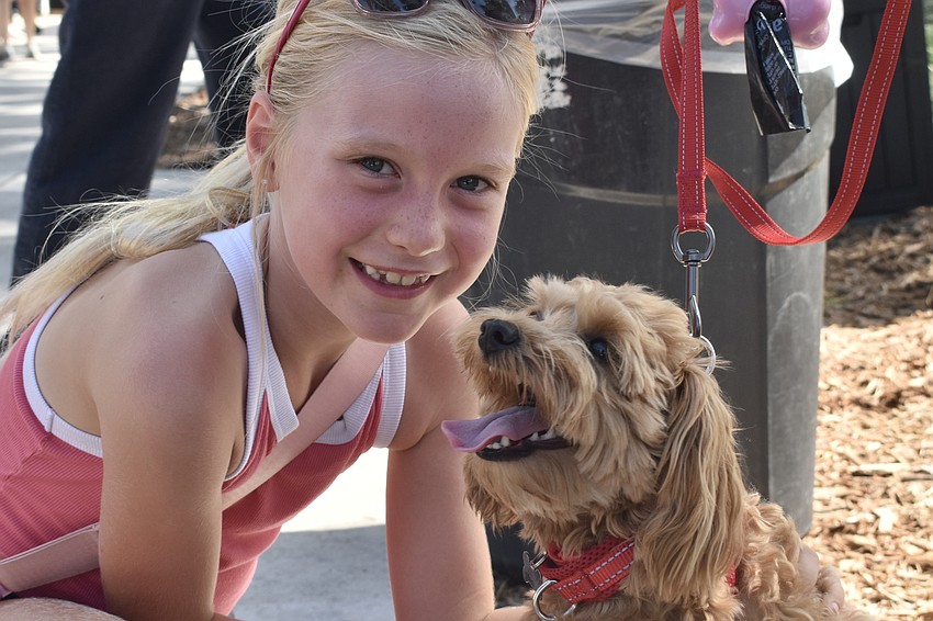 Avery Swertel, 8, meets Monica May's dog Daisy May.