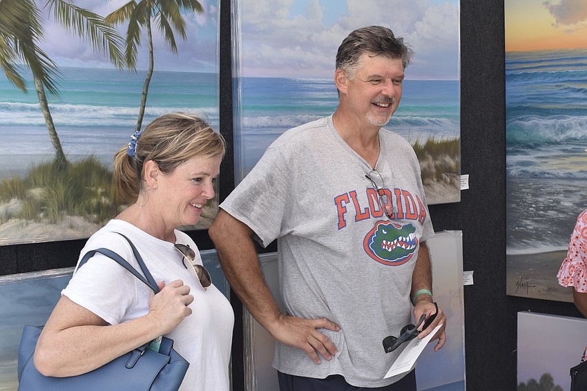 Heather and George Houck admire the artwork.