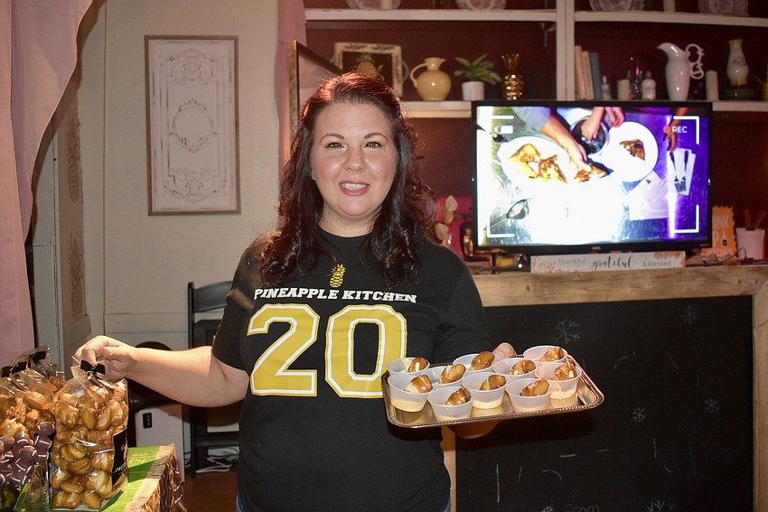 Shawna Hebert brings out a tray of the pretzel bites and dip, which is the appetizer that led to the Pineapple Kitchen opening on Lena Road.