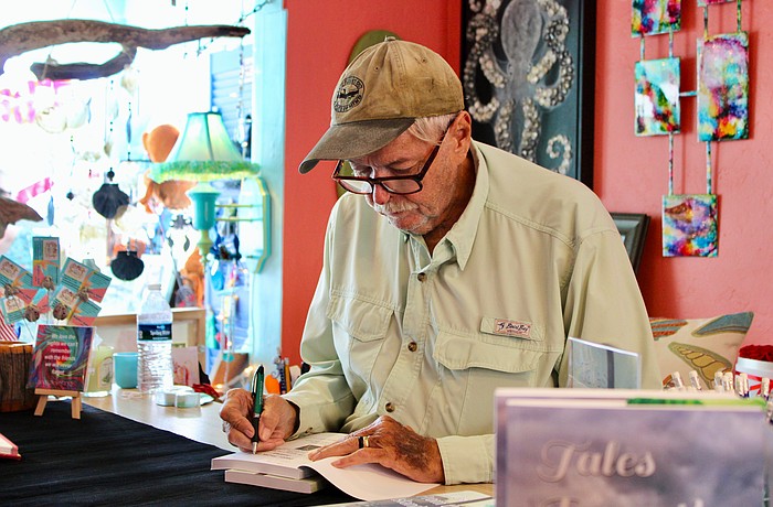 Author Alan Cross signs his newly released second book, "Tales from the Island: The Kingfish Boat Ramp Murders," on Sept. 13 at Three Island Monkeys.