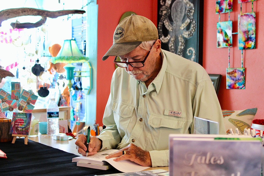 Author Alan Cross signs his newly released second book, "Tales from the Island: The Kingfish Boat Ramp Murders," on Sept. 13 at Three Island Monkeys.