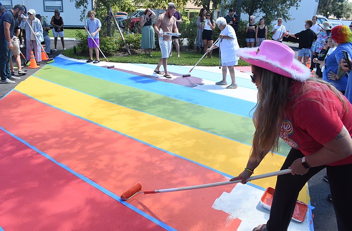 Attendees including Carissa Marsh (right) paint the walkway at The Harvest Sarasota on Sept. 14.