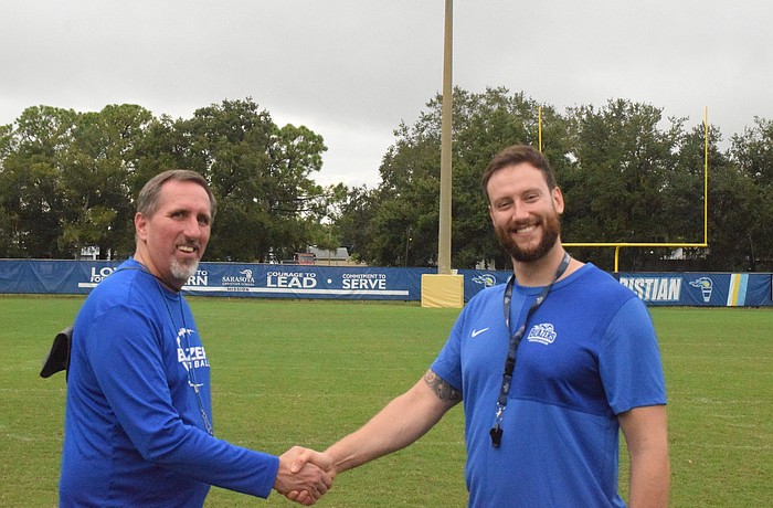 Sarasota Christian football coach Jacob Spenn (left) shakes hands with Krakow Kings U19 coach Robin Volkmar (right). After the Blazers visited Poland in June, Volkmar and one of his assistants visited Sarasota last week.