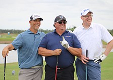 Steven Leone, Robert Carolla and Steve Nagy celebrate Carolla's hole in one, which is the first of his 40 year golfing career, at the Communi-tee Golf Classic by Lakewood Ranch Community Activities.