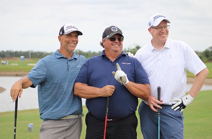 Steven Leone, Robert Carolla and Steve Nagy celebrate Carolla's hole in one, which is the first of his 40 year golfing career, at the Communi-tee Golf Classic by Lakewood Ranch Community Activities.