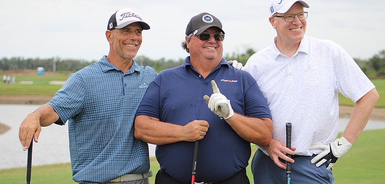 Steven Leone, Robert Carolla and Steve Nagy celebrate Carolla's hole in one, which is the first of his 40 year golfing career, at the Communi-tee Golf Classic by Lakewood Ranch Community Activities.