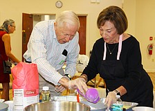 Jim Heskett and Marion Levine measure out flour for their challah at a free community baking workshop hosted Sept. 18 at Temple Beth Israel for Rosh Hashanah.