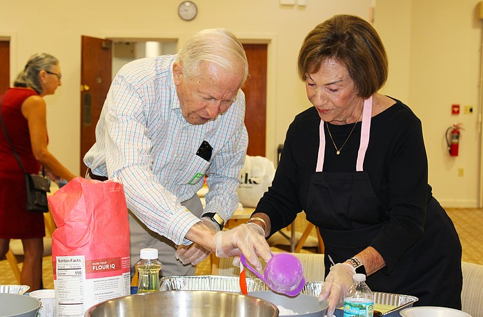 Jim Heskett and Marion Levine measure out flour for their challah at a free community baking workshop hosted Sept. 18 at Temple Beth Israel for Rosh Hashanah.