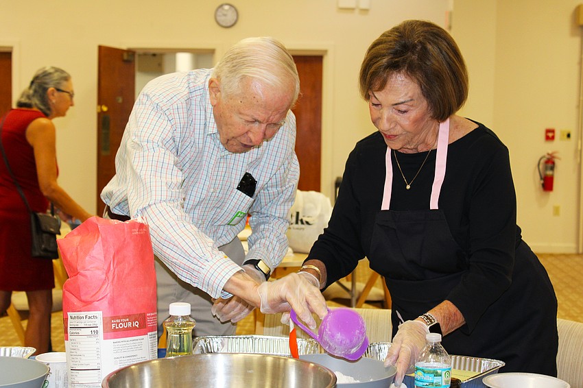 Jim Heskett and Marion Levine measure out flour for their challah at a free community baking workshop hosted Sept. 18 at Temple Beth Israel for Rosh Hashanah.