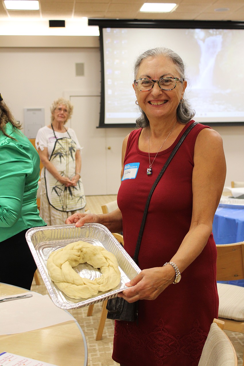 Sylvia Saba shows her round braided challah, a staple for celebrating Rosh Hashanah.