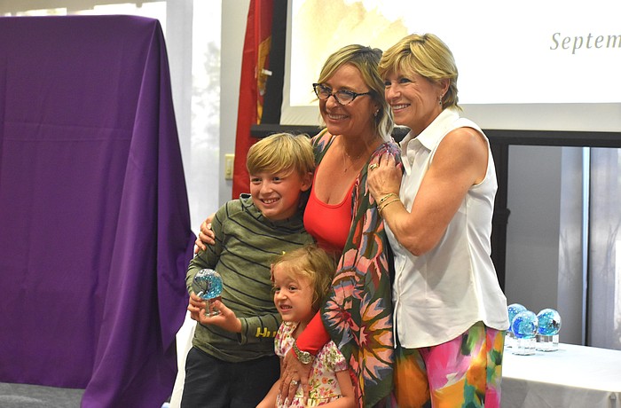 Raymond Perkowski, 10, and Ryan Avery Perkowski, 4, join their mother Allison Imre and Sisterhood For Good President Angela Massaro-Fain at an event to celebrate the beginning of Sisterhood For Good's fifteenth year.