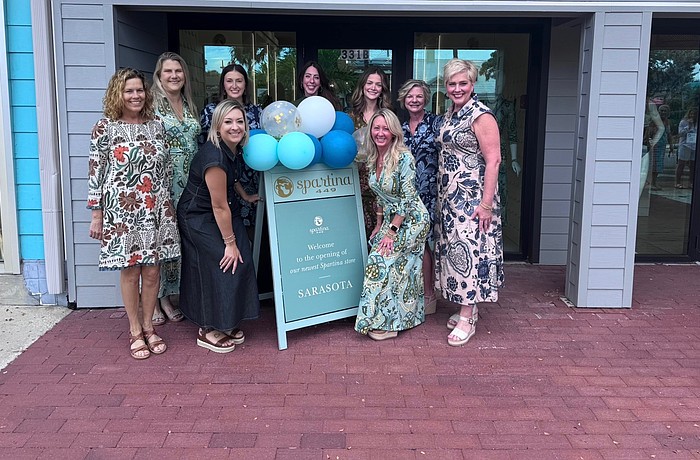 Staff at the newly opened Spartina 449 on St. Armands Circle celebrate the opening of the clothing boutique this month. The brand blends flowery linens and leather goods.