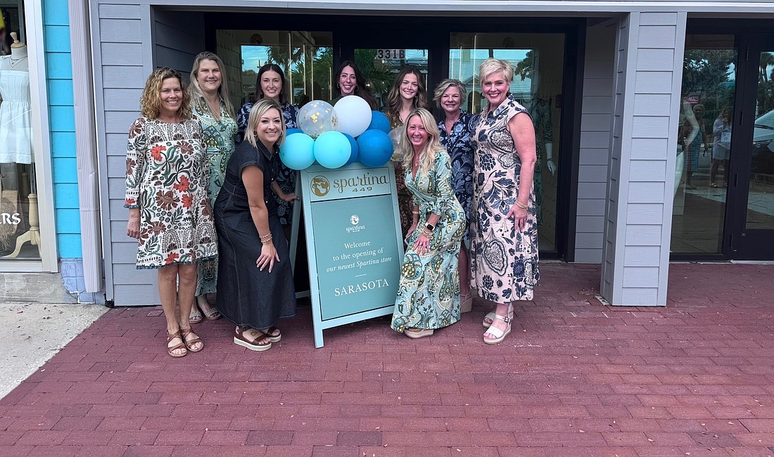Staff at the newly opened Spartina 449 on St. Armands Circle celebrate the opening of the clothing boutique this month. The brand blends flowery linens and leather goods.