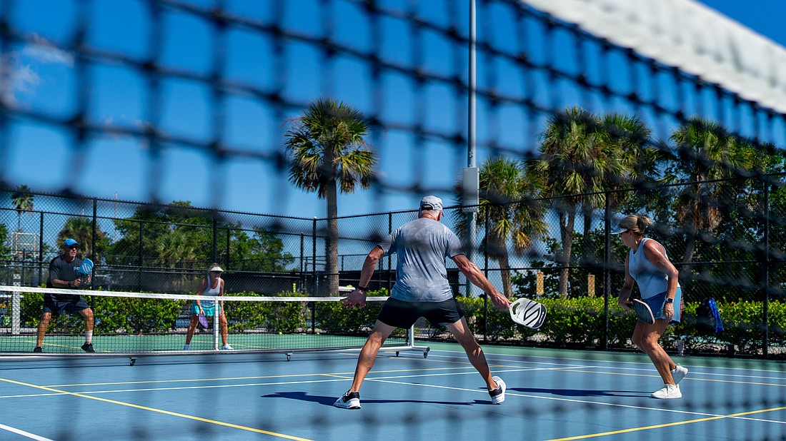 From left to right: Chris Vito, Penny Sellers, Dave Boone and Cathy Boone play a game of pickleball at the multipurpose Bayfront Park courts in Longboat Key Friday, Sept. 19.