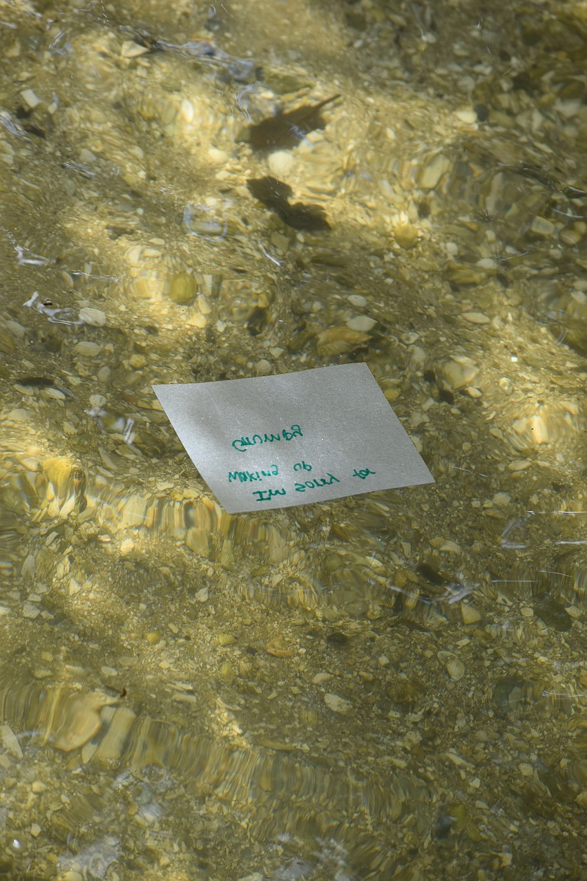 A note floats away in the water.