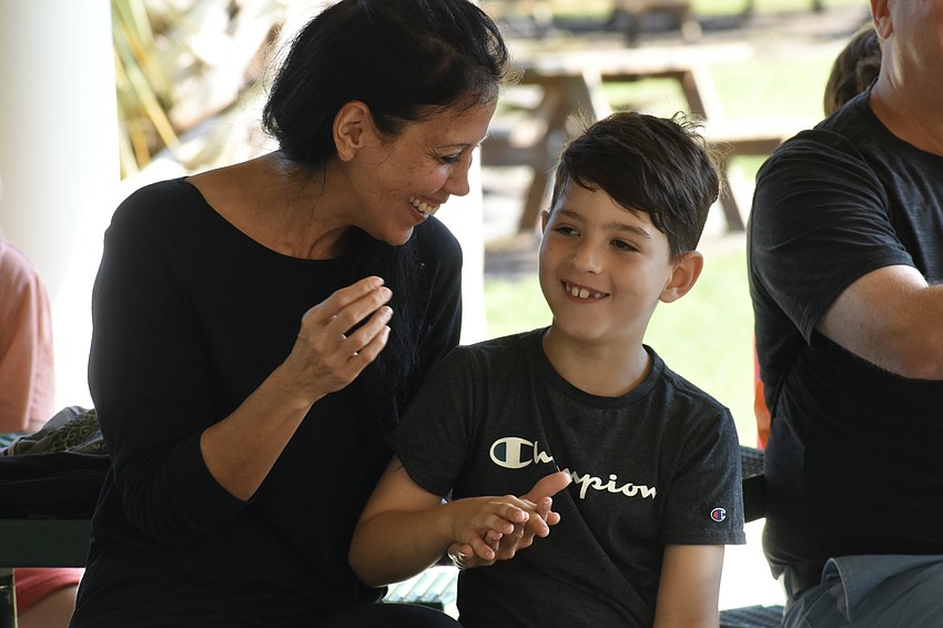 Melissa Allen and her son Asher Allen, 7, participate in the opening music together.