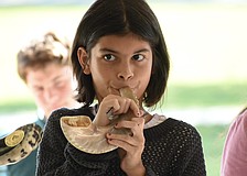 Vivian Masters, 10, blows the shofar.
