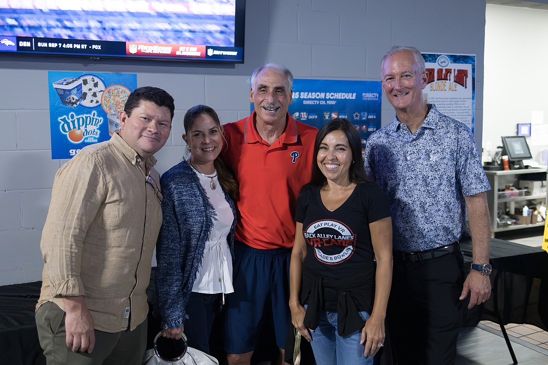 William Sanchez, executive director of the Cultural Awareness Fund; his wife Maria Beatriz Añez; Volusia County Sheriff Mike Chitwood; Maria Trent, Cultural Awareness Fund director and Back Alley Lanes proprietor; and Buck James, CEO of the Domestic Abuse Council of Volusia. Courtesy photo