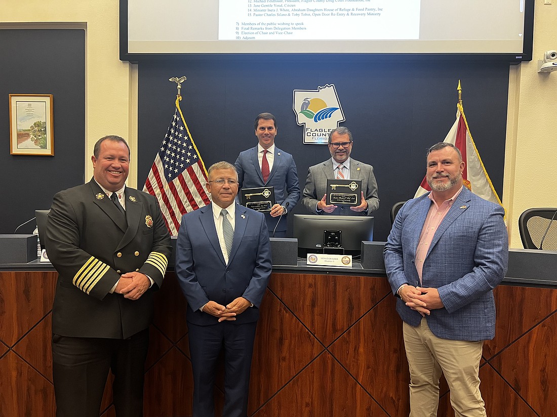 PCFD Fire Chief Kyle Berryhill, Palm Coast Mayor Mike Norris and Councilman Ty Miller (front row) present Florida Rep. Sam Greco and Sen. Tom Leek (back row) with keys to the city of Palm Coast. Courtesy photo