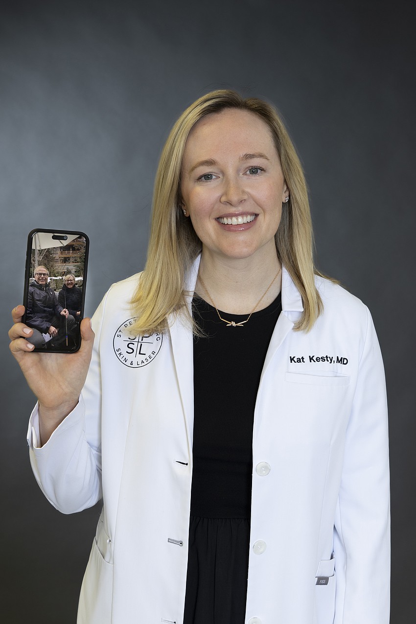 Dr. Kat Kesty with a photo of her parents and mentors.