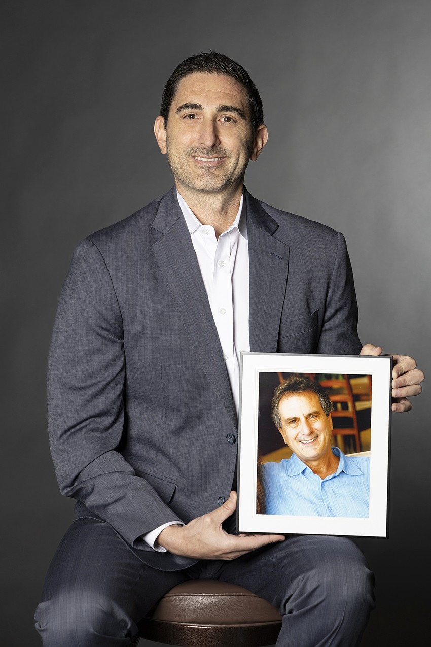 Morgan Richmond with a photo of his late father Mark Richmond.