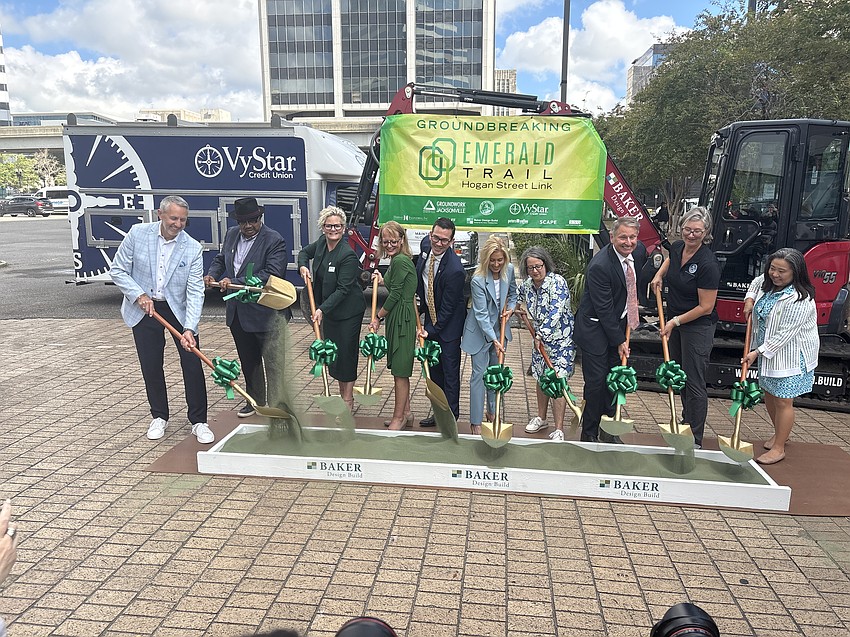 City and private leaders break ground Sept. 25 using emerald-tinted sand for the Hogan Street Link section of the Emerald Trail.