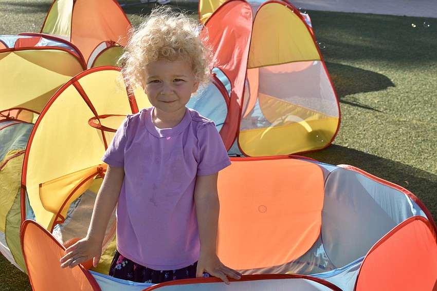 East County's Kenzie Evans, 2, pops up from the tunnel after a long crawl.