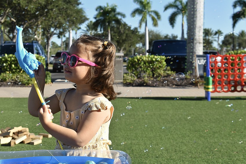 Lakewood Ranch's Danika Hernandez, 2, stops fishing to fix her reel.