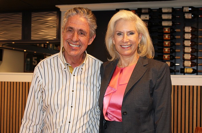 Outgoing Kiwanis Club of Longboat Key president Michael Garey passes the gavel to Danielle Gladding at a Sept. 25 meeting at his restaurant, the Lazy Lobster.